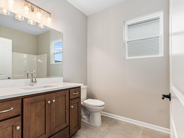 bathroom featuring a shower, toilet, and vanity