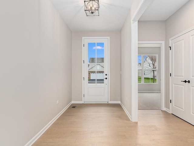 entryway featuring a notable chandelier and light hardwood / wood-style floors