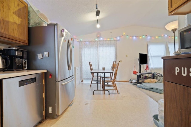 kitchen with a textured ceiling and stainless steel appliances