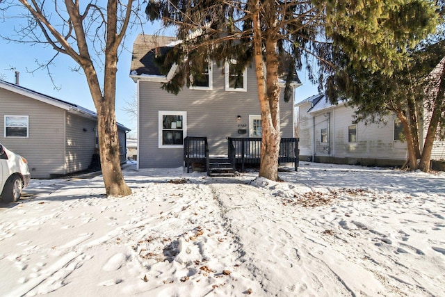 snow covered property featuring a wooden deck