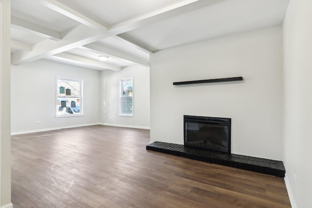 unfurnished living room with dark hardwood / wood-style flooring and beam ceiling