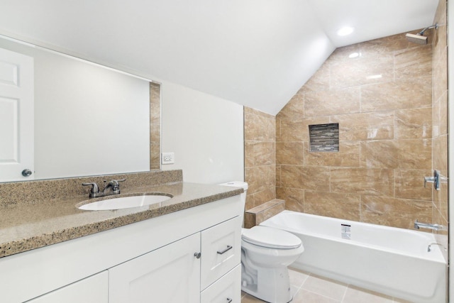 full bathroom featuring tile patterned flooring, vaulted ceiling, tiled shower / bath combo, toilet, and vanity