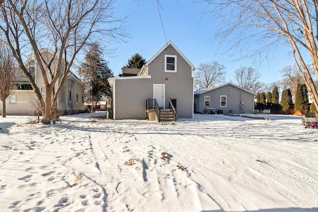 view of snow covered back of property