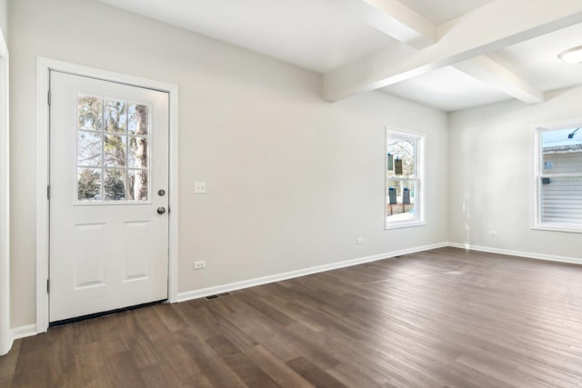 foyer featuring beam ceiling and dark wood-type flooring