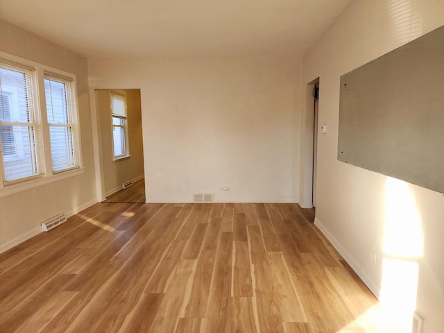 unfurnished room with light hardwood / wood-style floors