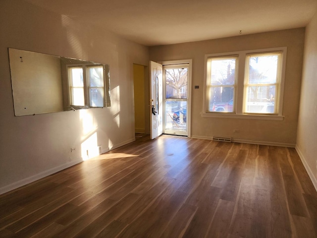 spare room with dark wood-type flooring