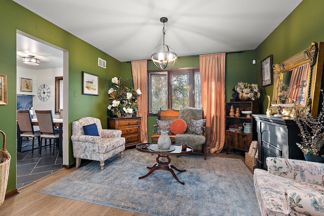 living room with a notable chandelier and wood-type flooring