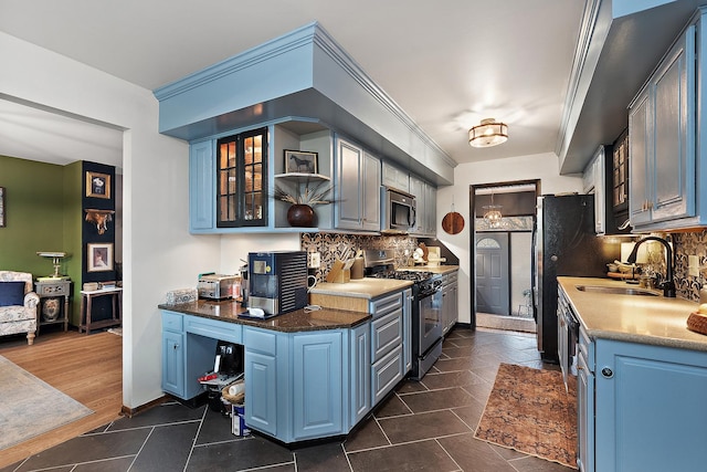 kitchen featuring tasteful backsplash, sink, blue cabinets, and appliances with stainless steel finishes