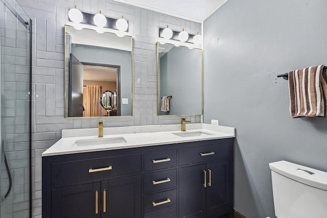 bathroom featuring vanity, toilet, and a shower with door