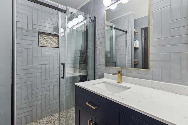 bathroom with vanity and a shower with door