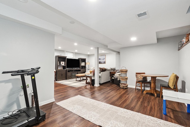 exercise room featuring dark wood-type flooring