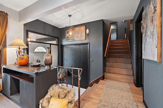 foyer entrance featuring a notable chandelier and light wood-type flooring