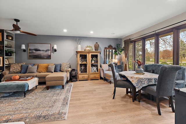 living room featuring light wood-type flooring and ceiling fan