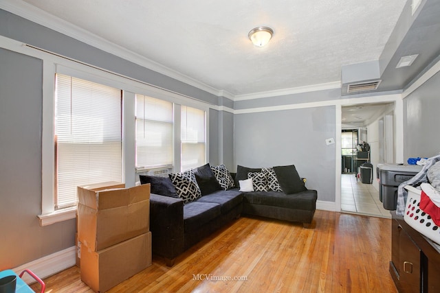 living room featuring hardwood / wood-style flooring and ornamental molding