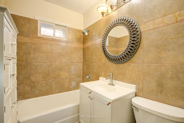 full bathroom featuring vanity, toilet, tile walls, and tiled shower / bath