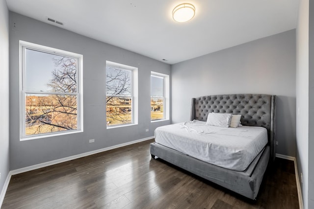 bedroom with dark wood-type flooring