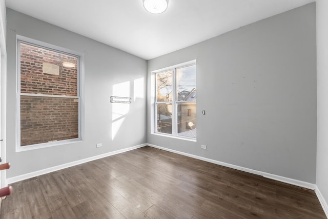 spare room featuring dark hardwood / wood-style flooring