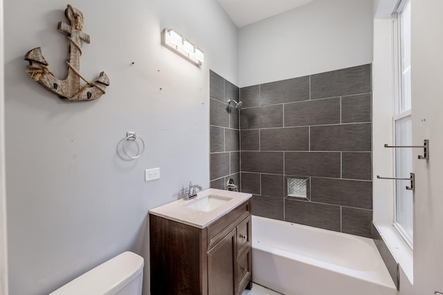 full bathroom with vanity, toilet, plenty of natural light, and tiled shower / bath combo