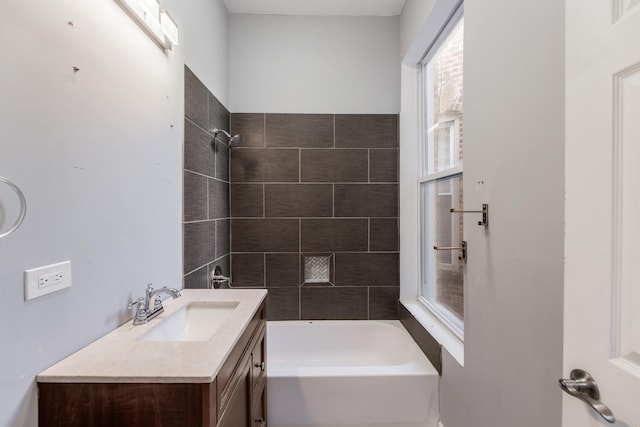 bathroom with vanity and tiled shower / bath