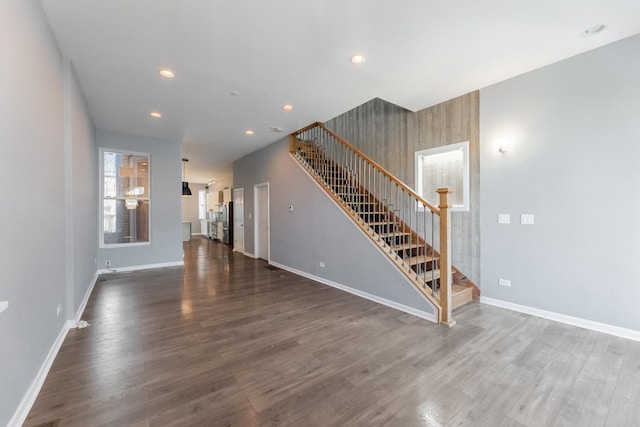 unfurnished living room with dark hardwood / wood-style floors