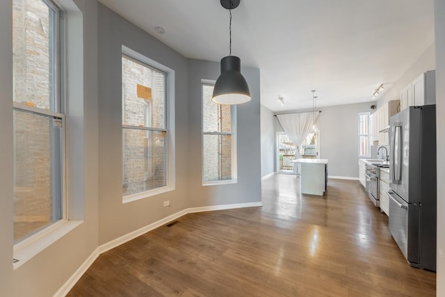 unfurnished dining area featuring hardwood / wood-style floors and sink