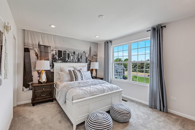 bedroom featuring light carpet