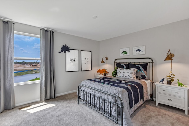 bedroom featuring light colored carpet