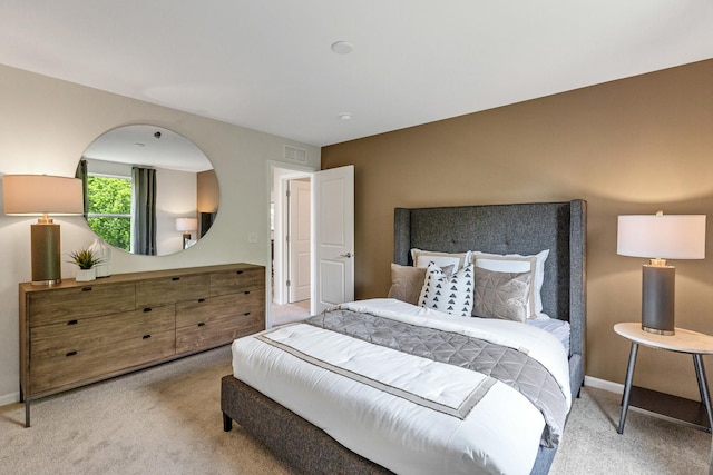 bedroom featuring light carpet