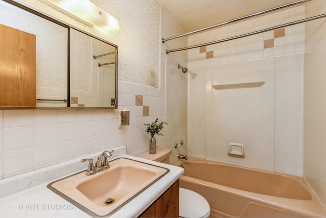 full bathroom with tasteful backsplash, vanity, shower / bathing tub combination, tile walls, and toilet