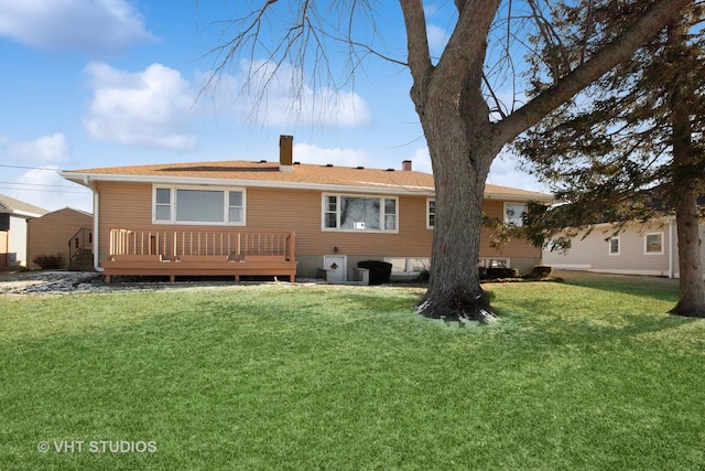 back of house with a yard and a wooden deck