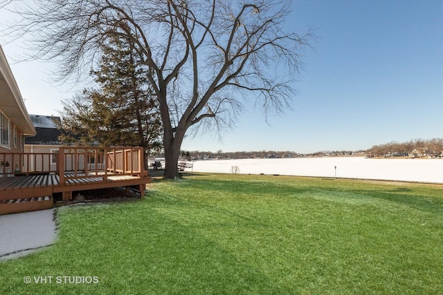 view of yard with a deck with water view