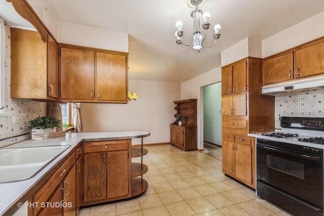 kitchen featuring decorative light fixtures, decorative backsplash, black gas range oven, and an inviting chandelier