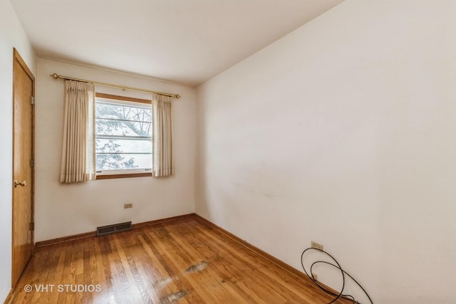 spare room featuring hardwood / wood-style floors