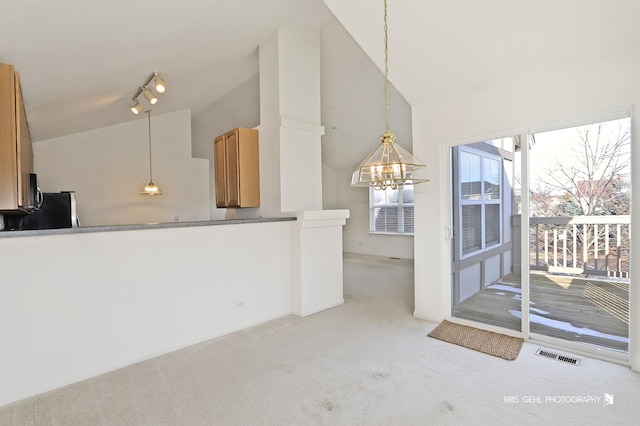 living room featuring a notable chandelier, light colored carpet, and high vaulted ceiling