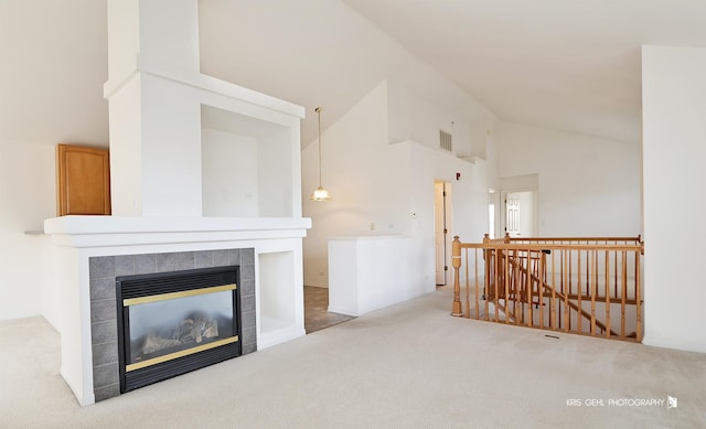 living room with a fireplace, carpet, and high vaulted ceiling