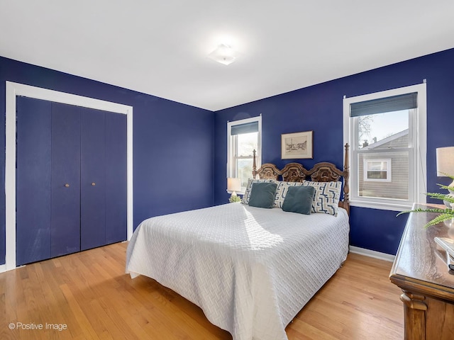 bedroom with light hardwood / wood-style flooring and multiple windows