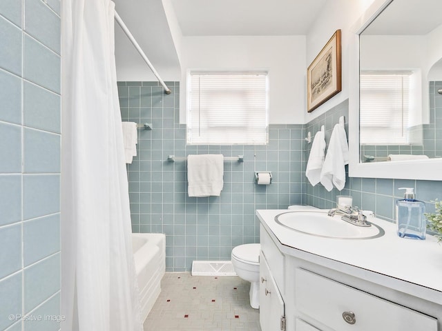 full bathroom featuring tile patterned flooring, tile walls, toilet, shower / bath combo, and vanity