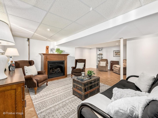 living room featuring a drop ceiling