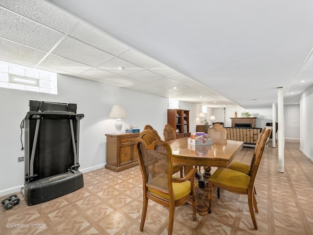 dining space featuring a drop ceiling