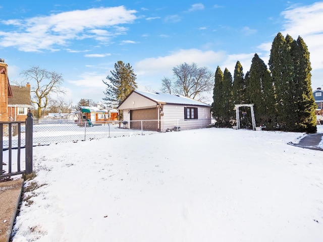 snowy yard with a garage