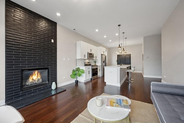 living room with sink and dark hardwood / wood-style floors