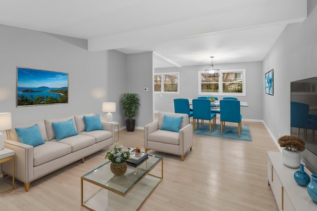 living room featuring a chandelier and light hardwood / wood-style floors