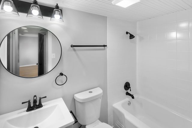 full bathroom with vanity, tiled shower / bath combo, and toilet