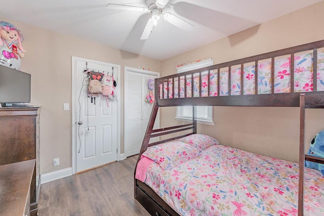 bedroom featuring hardwood / wood-style floors, ceiling fan, and a closet