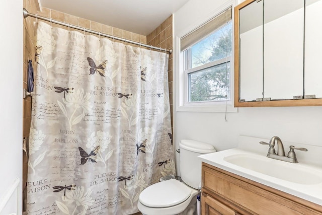 bathroom featuring vanity, a shower with shower curtain, and toilet