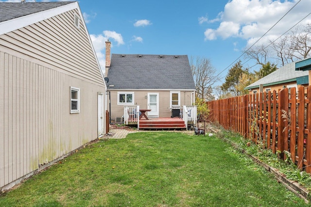 rear view of house featuring a yard and a wooden deck