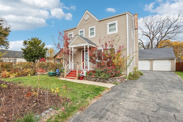 view of front of property with an outbuilding, a front yard, and a garage