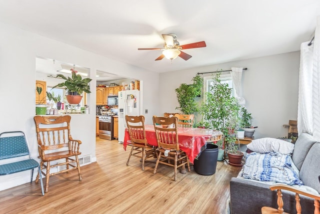 dining room with light wood-type flooring and ceiling fan