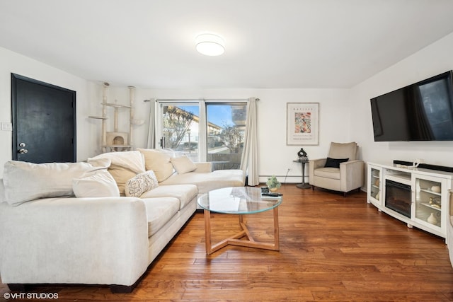 living room featuring hardwood / wood-style flooring and baseboard heating