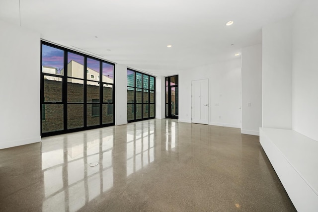 unfurnished room featuring floor to ceiling windows